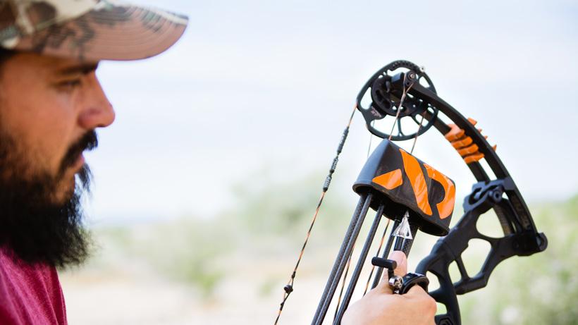 Hunter inspecting bow