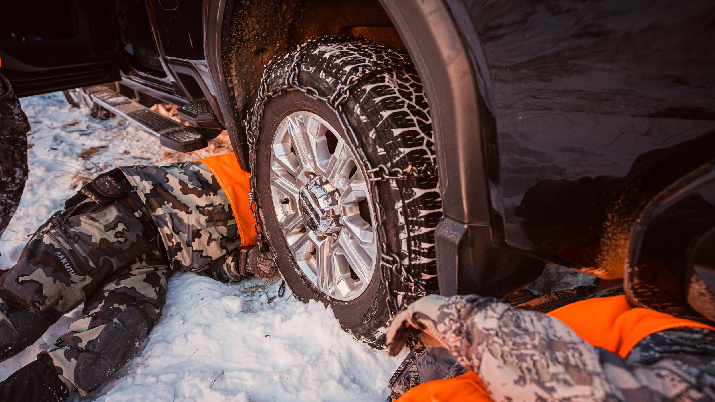 Putting on truck tire chains on late season mule deer rut hunt