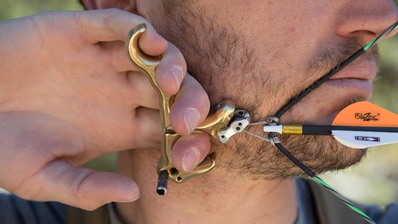 Trail kreitzer at full draw using a hinge style archery release for hunting