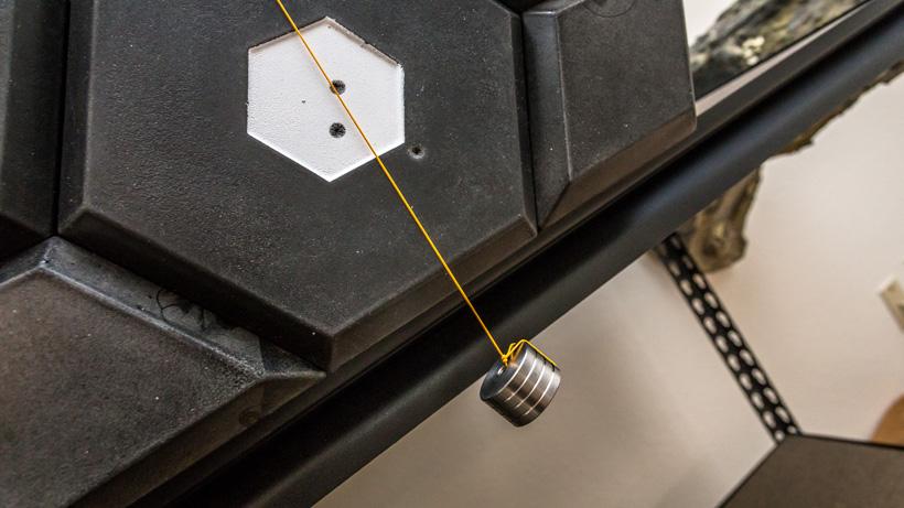 Hanging a weight from string on matrix archery target