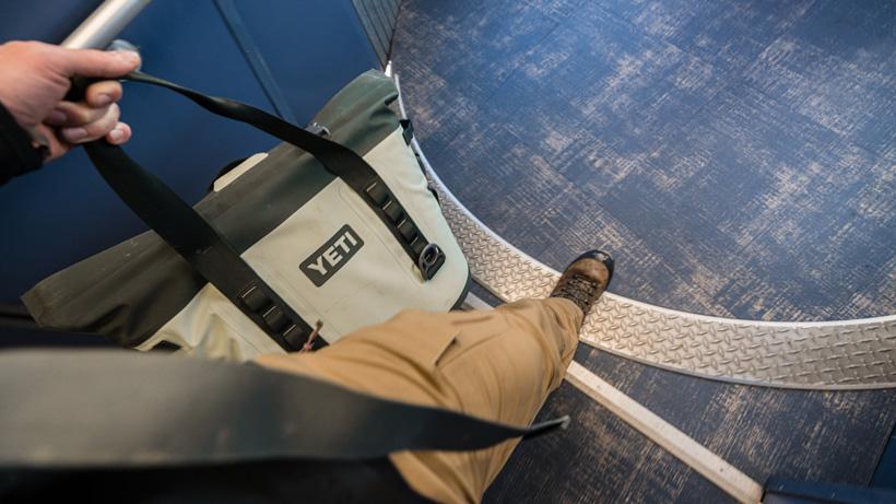 Walking out of airplane with yeti hopper m30 cooler