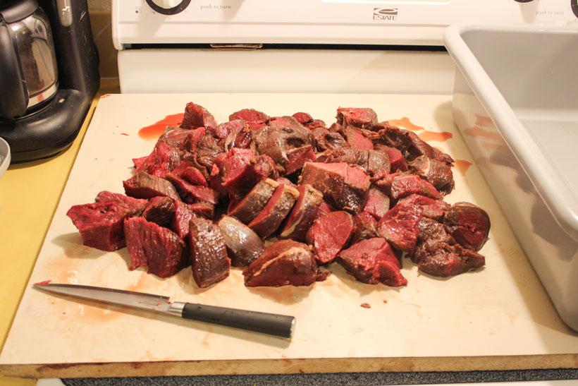 Cutting up meat for grinder 2