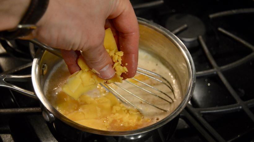Adding cheese to the pot